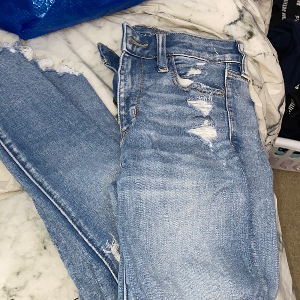 AE next level stretch light wash jeans with rips